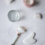 spa supplies for skincare procedures placed on marble table